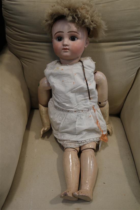 A late 19th century German bisque head doll 29in.